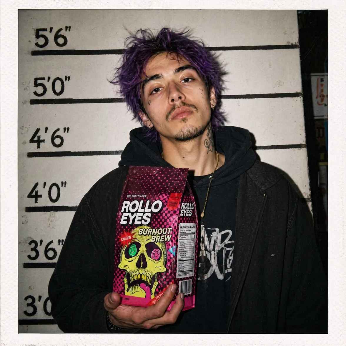 A purple-haired model holding the Rollo Eyes Burnout Brew coffee bag against a police-lineup height chart, Polaroid framed